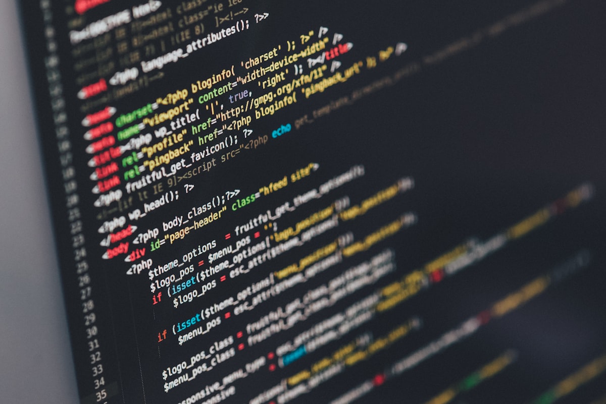 Developer writing code on a laptop